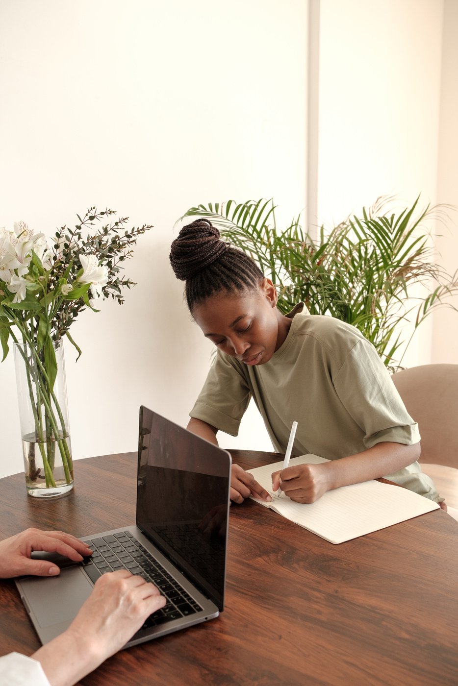 Female Client Writing on Notebook during Therapy Session